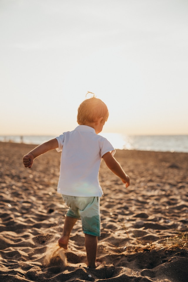 young boy exploring the outdoors in summertime