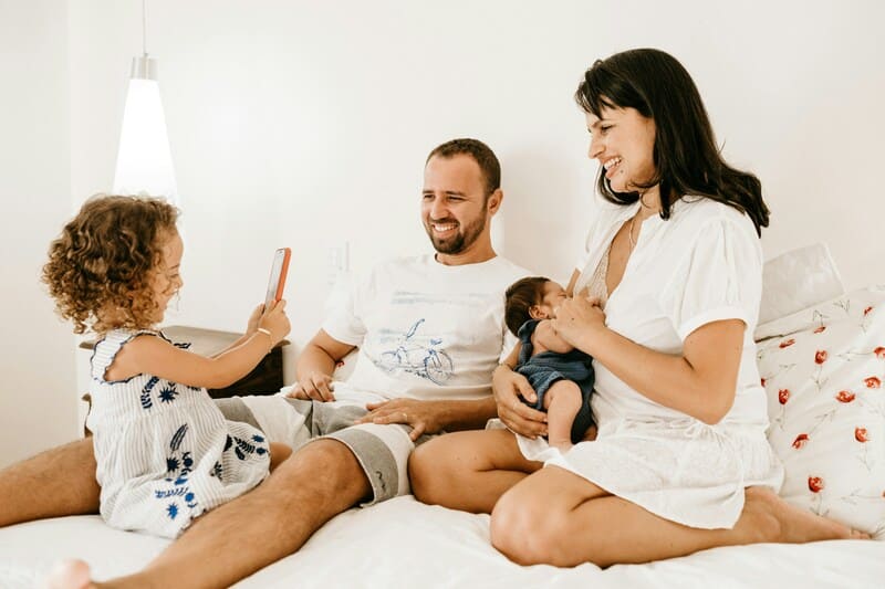 parents smiling and laughing with small children